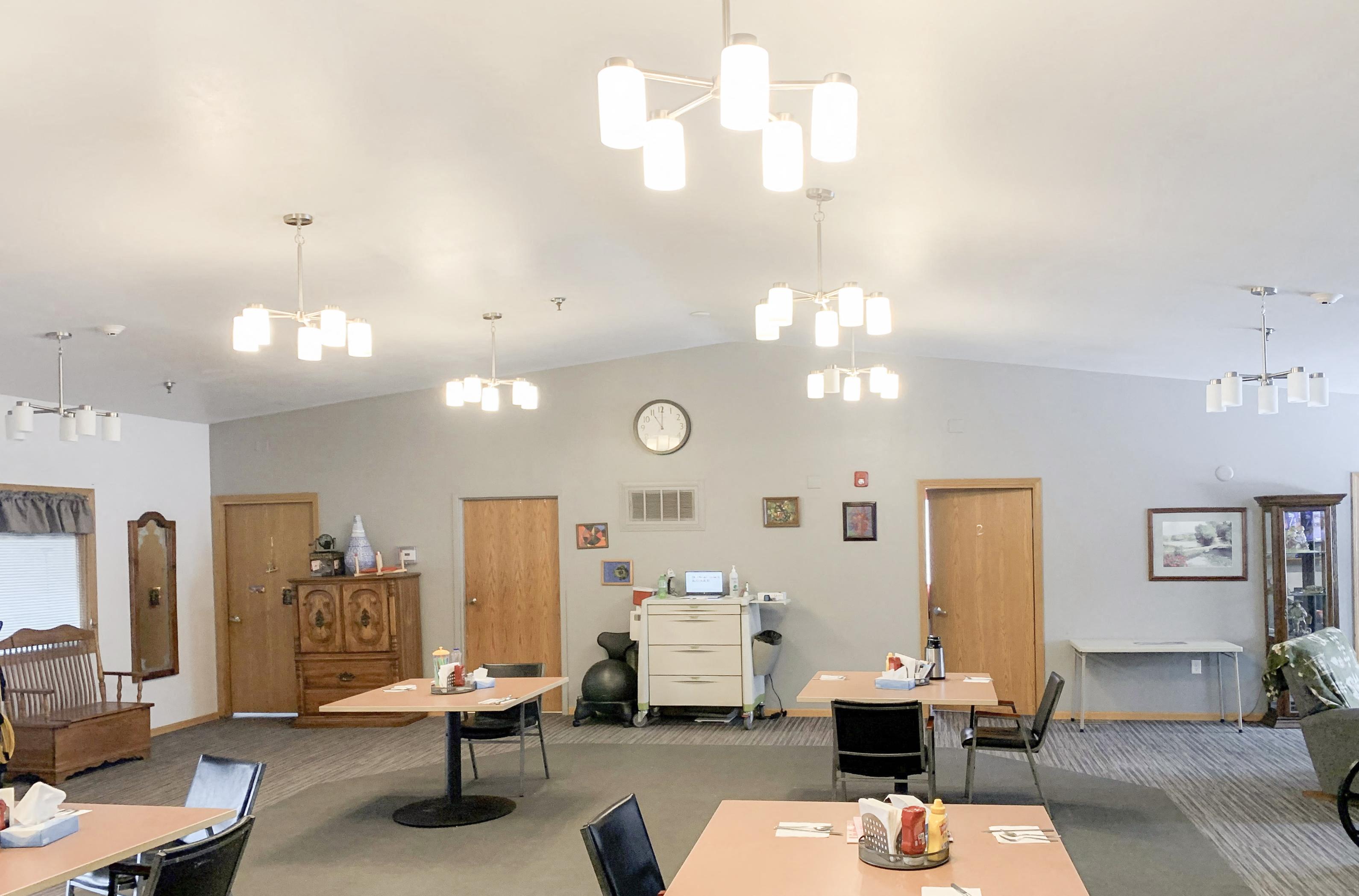 A room with a white ceiling and a clock on the wall.,A room with a white ceiling and a clock on the wall.